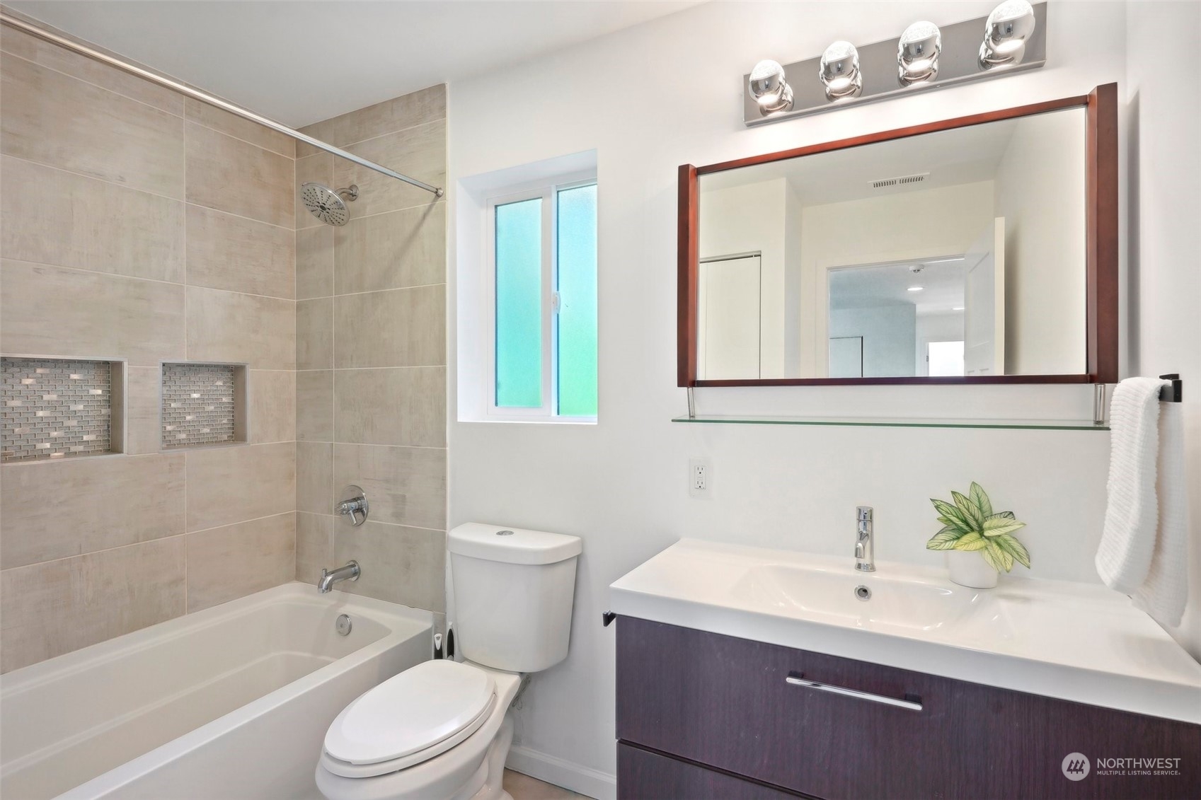 7453 Gatewood Road Southwest Seattle, WA 98136 - Photo 27 of 40 a bathroom with a sink a toilet a mirror and shower