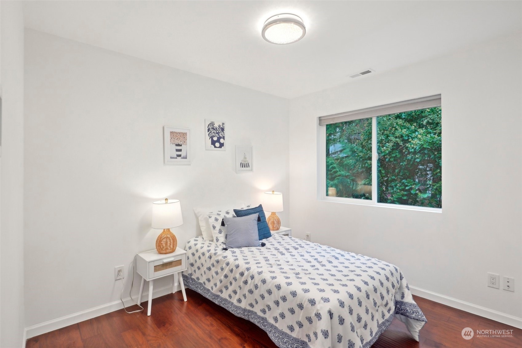7453 Gatewood Road Southwest Seattle, WA 98136 - Photo 30 of 40 a bedroom with a bed and wooden floor
