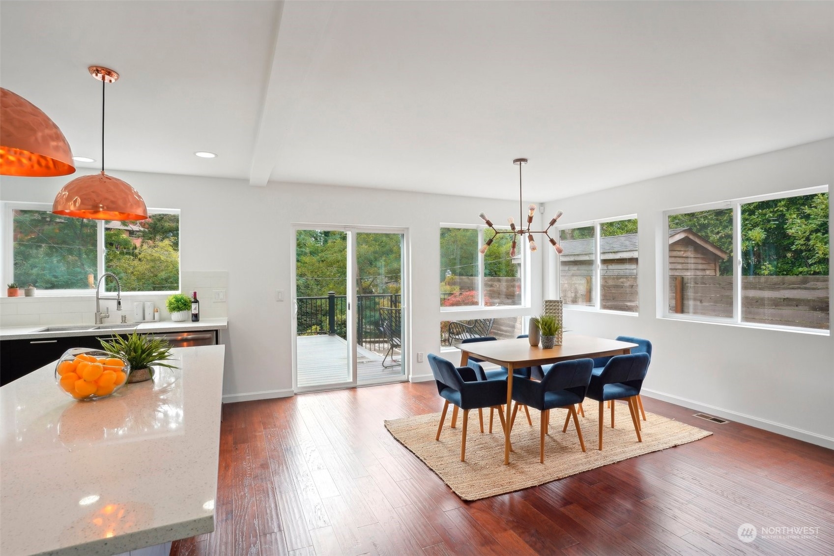 7453 Gatewood Road Southwest Seattle, WA 98136 - Photo 6 of 40 a view of a dining room with furniture wooden floor and chandelier