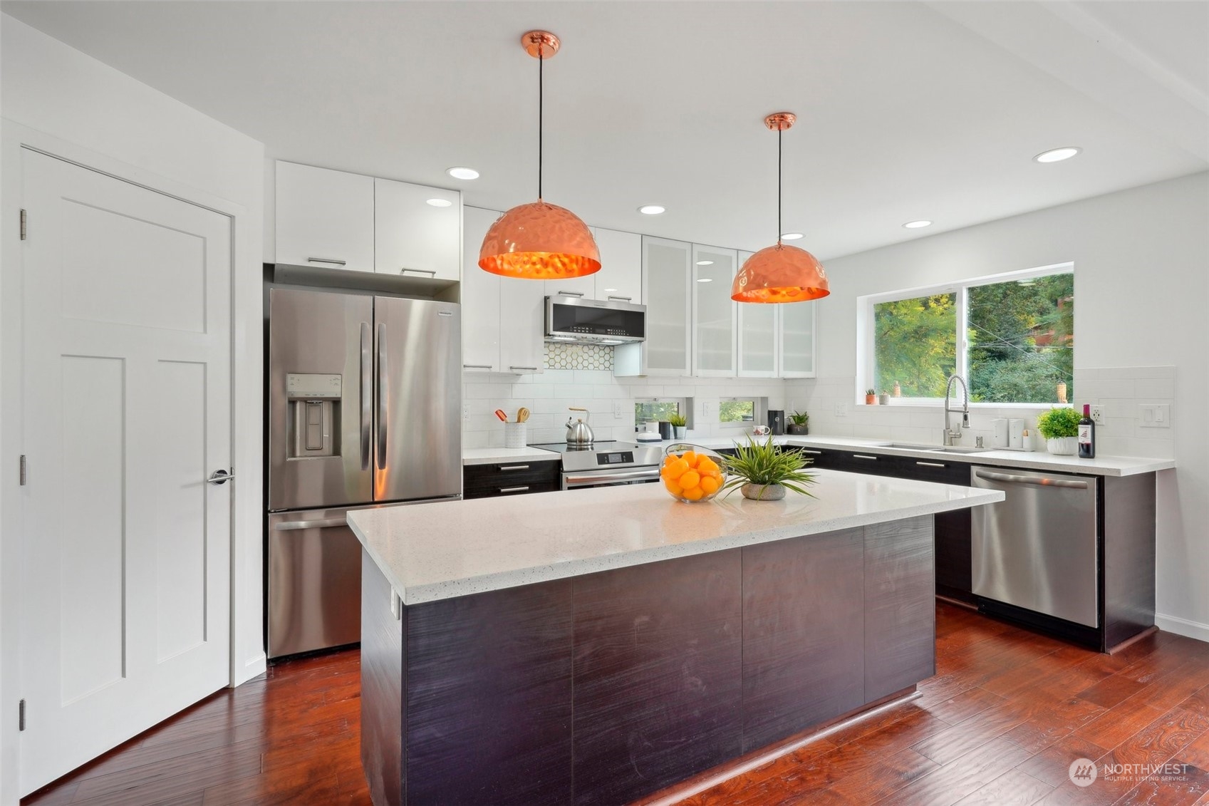 7453 Gatewood Road Southwest Seattle, WA 98136 - Photo 9 of 40 a kitchen that has a lot of cabinets and wooden floor