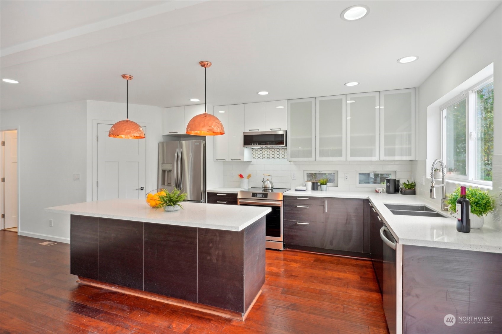 7453 Gatewood Road Southwest Seattle, WA 98136 - Photo 10 of 40 a kitchen with stainless steel appliances granite countertop a sink a stove and a wooden floors
