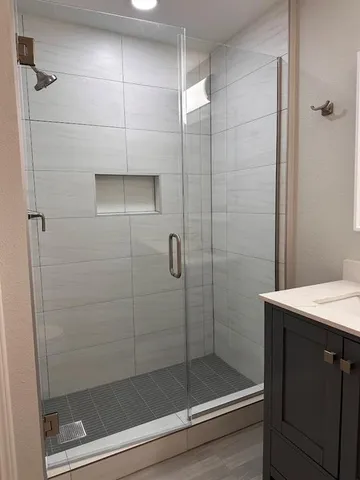 a bathroom with a shower and a sink