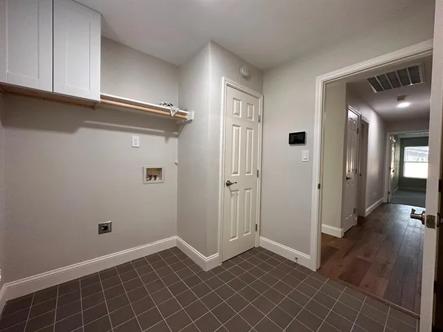 an empty room with a empty space and windows