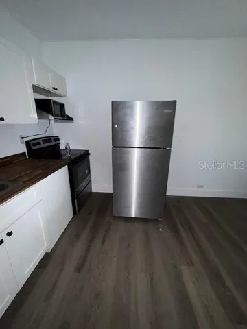 a kitchen with a refrigerator and a stove