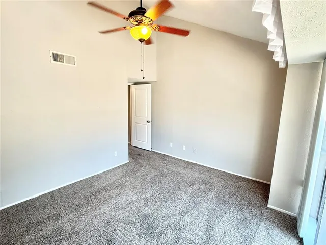 a view of an empty room and a window