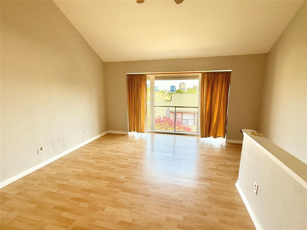 4545 North O'Connor Road, Unit 2251 Irving, TX 75062 - Photo 19 of 25 a view of an empty room with wooden floor and a window