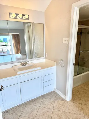 a bathroom with a tub sink and mirror