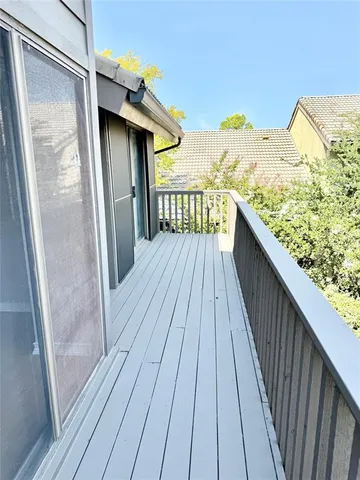 a view of balcony with wooden floor