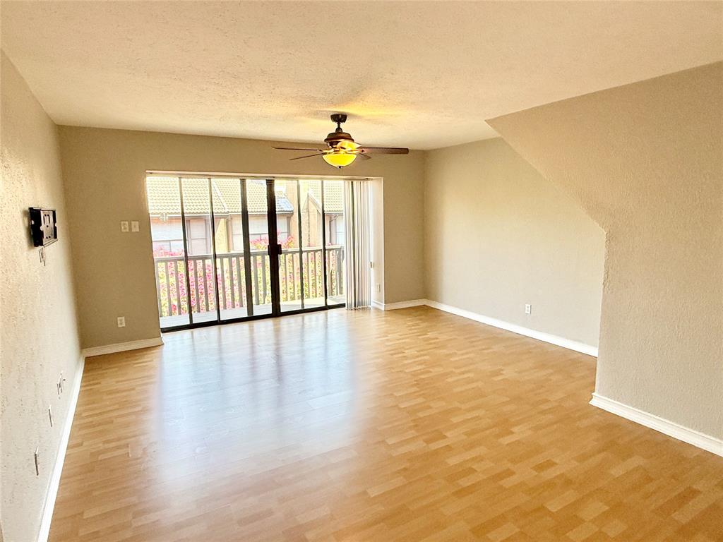 4545 North O'Connor Road, Unit 2251 Irving, TX 75062 - Photo 3 of 25 an empty room with wooden floor and windows