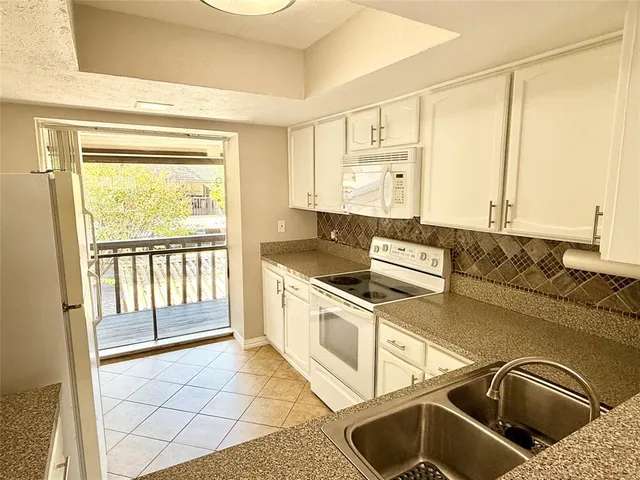 a kitchen that has a sink and a stove