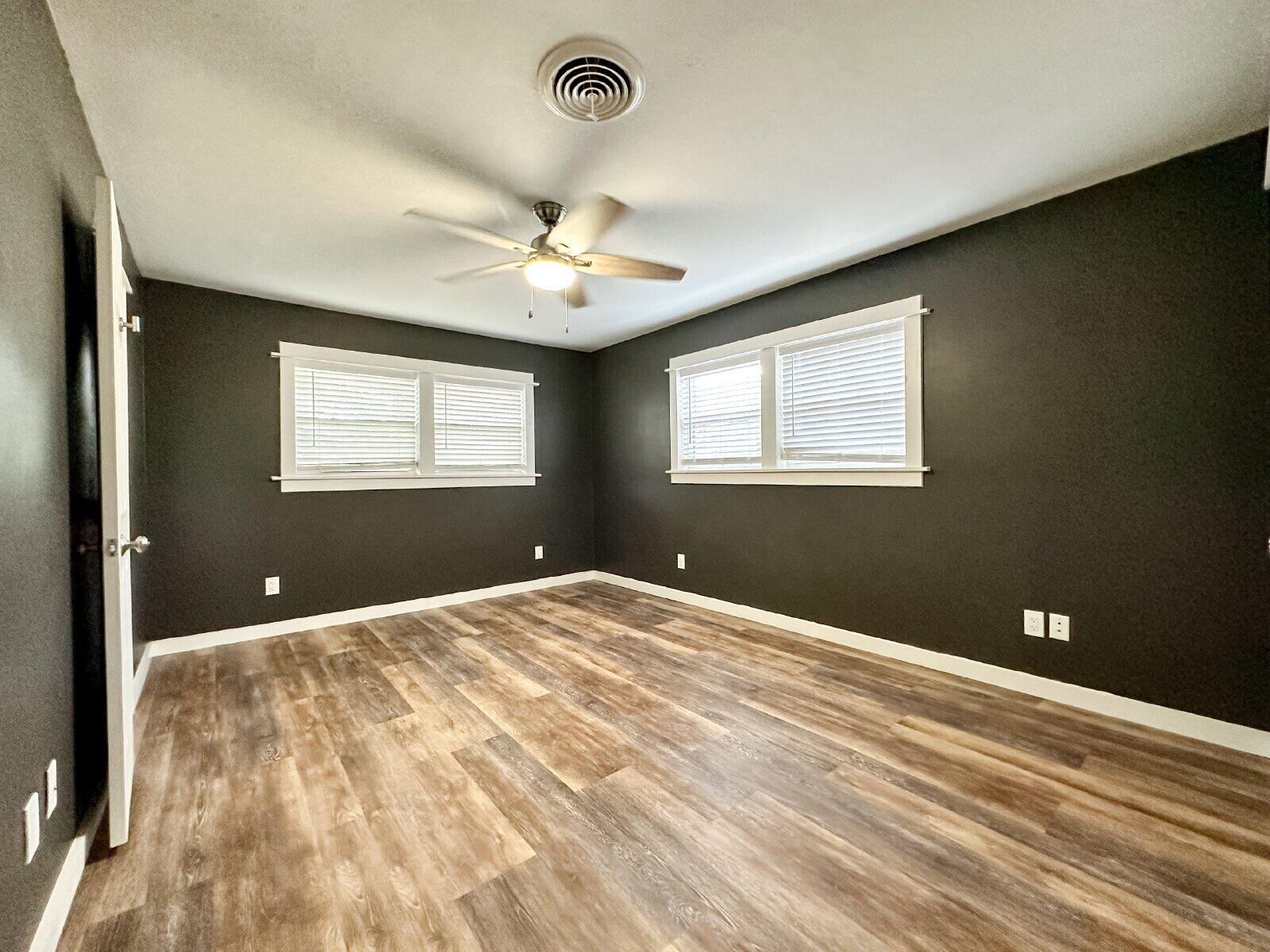 2608 Raleigh Avenue Lubbock, TX 79410 - Photo 12 of 23 a view of a bedroom with a large bed and a chandelier