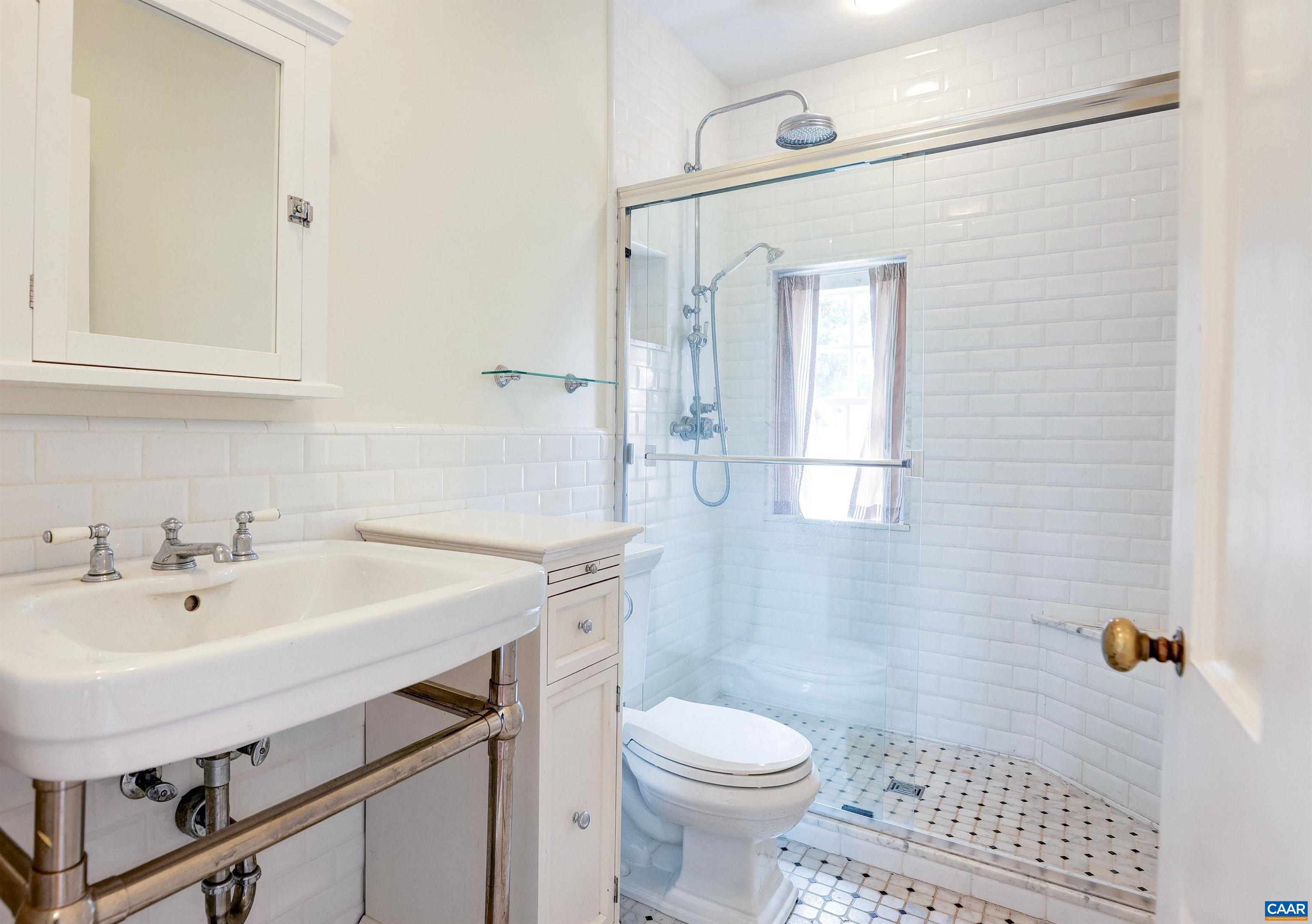 3466 Morgantown Road Charlottesville, VA 22903 - Photo 19 of 35 a bathroom with a sink a toilet a mirror and shower