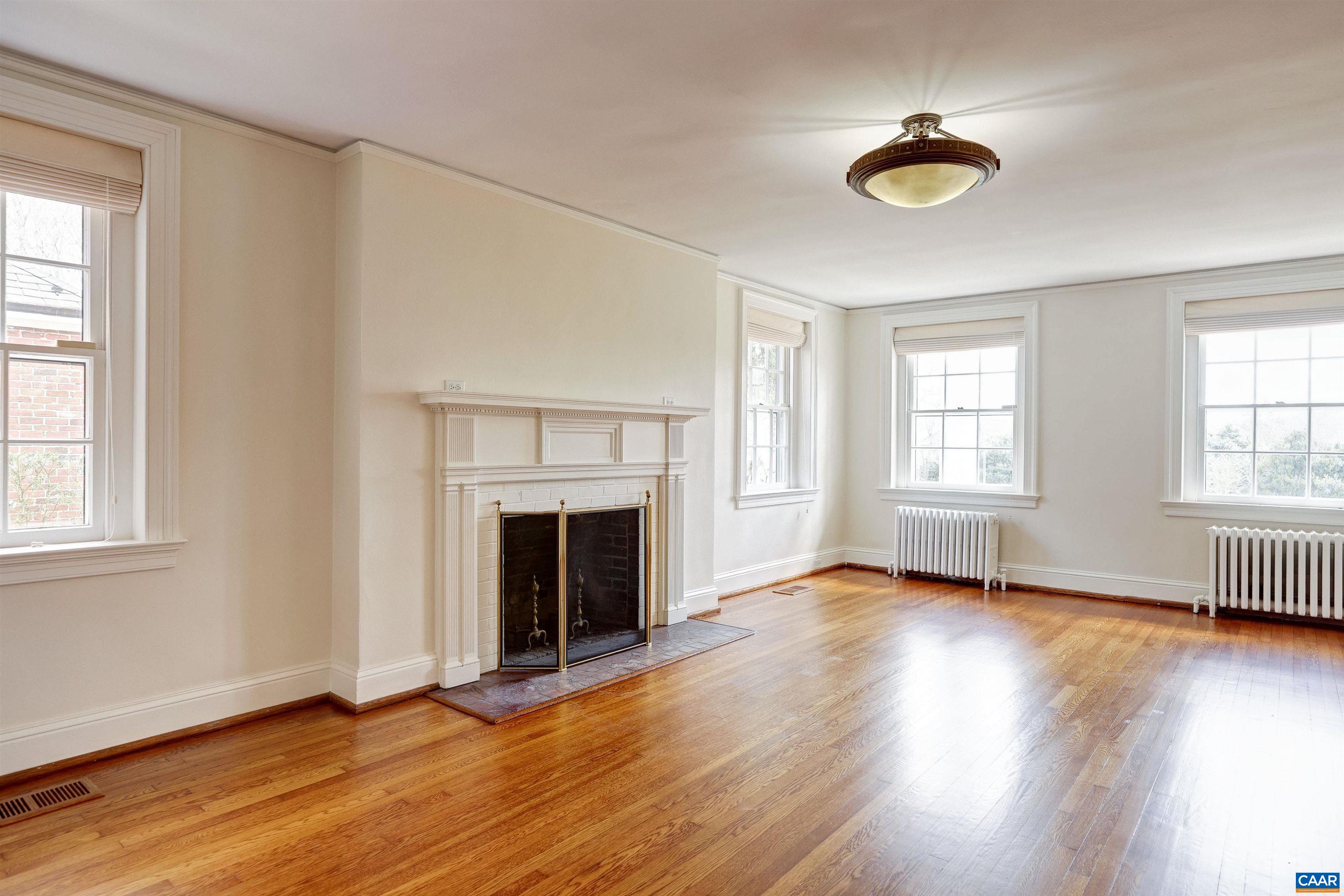 3466 Morgantown Road Charlottesville, VA 22903 - Photo 4 of 35 an empty room with windows fireplace and wooden floor