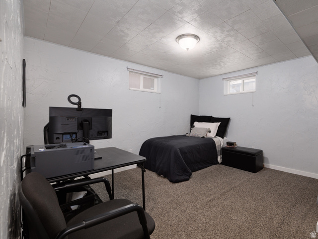 8252 Wood Street Midvale, UT 84047 - Photo 18 of 40 Carpeted room featuring white paneling, a drop ceiling, and a two windows