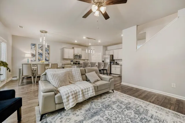 a living room with furniture and kitchen view