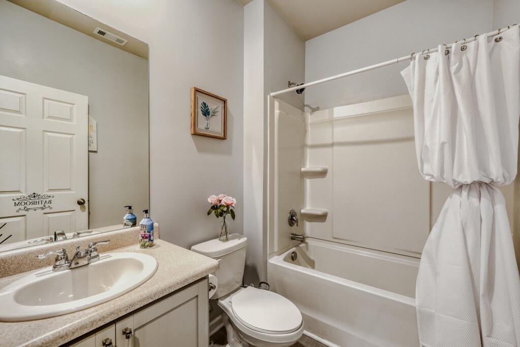 1526 Woodvale Street Hampton, GA 30228 - Photo 16 of 31 a bathroom with a sink toilet and shower