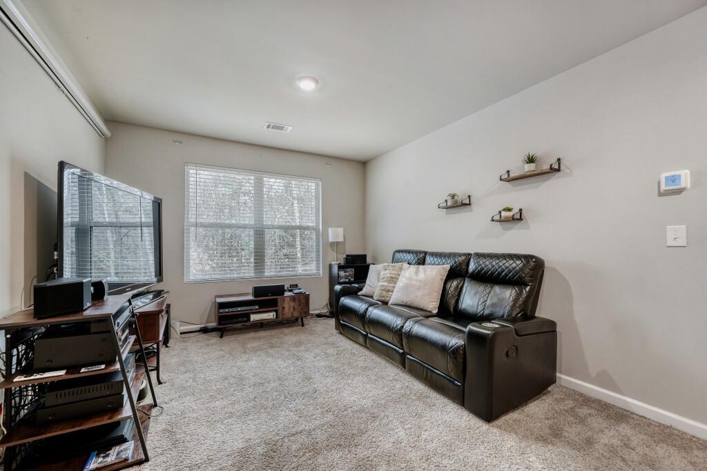 1526 Woodvale Street Hampton, GA 30228 - Photo 17 of 31 a living room with furniture and a flat screen tv