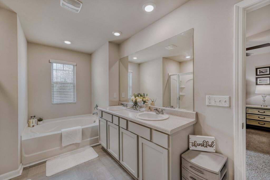 1526 Woodvale Street Hampton, GA 30228 - Photo 20 of 31 a bathroom with a tub sink and mirror