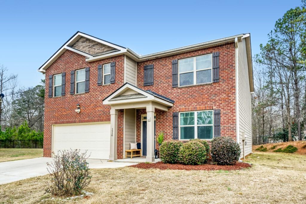 1526 Woodvale Street Hampton, GA 30228 - Photo 2 of 31 a front view of a house with a yard