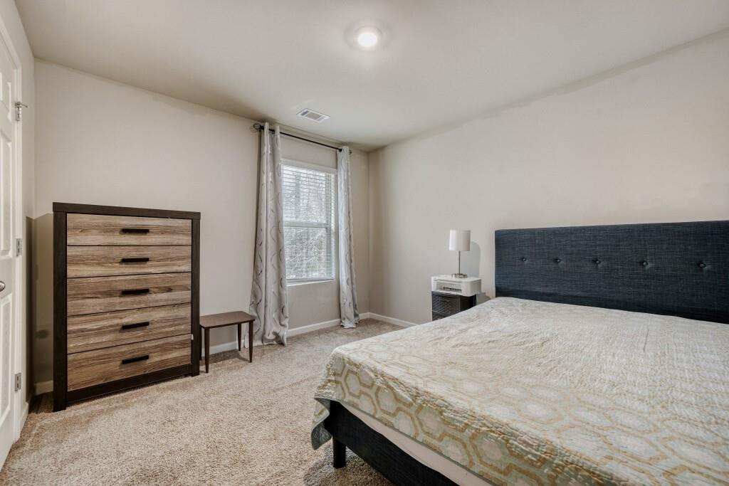 1526 Woodvale Street Hampton, GA 30228 - Photo 23 of 31 a bedroom with a bed and a dresser