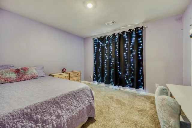 a bedroom with a bed window and walk in closet