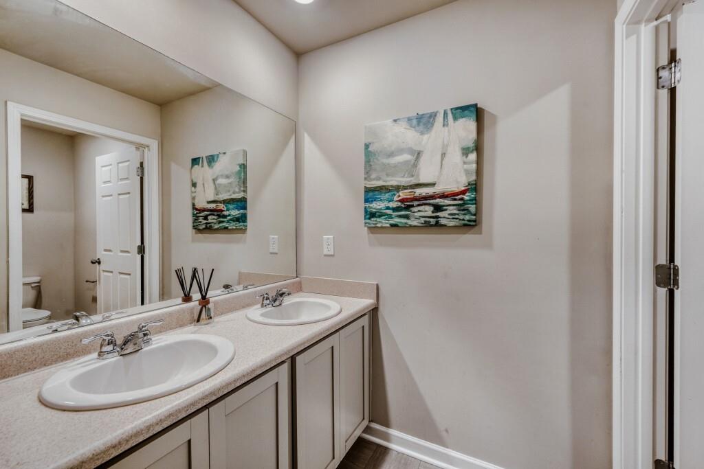 1526 Woodvale Street Hampton, GA 30228 - Photo 25 of 31 a bathroom with a sink and a mirror