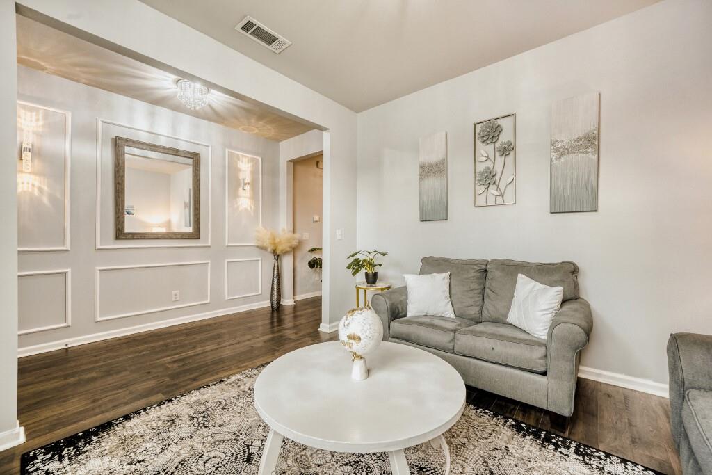 1526 Woodvale Street Hampton, GA 30228 - Photo 7 of 31 a living room with furniture and a wooden floor