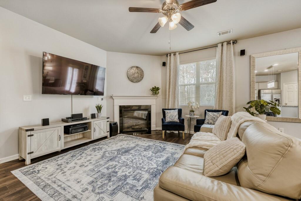 1526 Woodvale Street Hampton, GA 30228 - Photo 8 of 31 a spacious bedroom with a bed and a flat screen tv