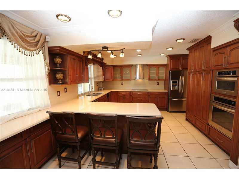 3845 Southwest 128th Avenue Miami, FL 33175 - Photo 11 of 35 a kitchen with a sink refrigerator and cabinets