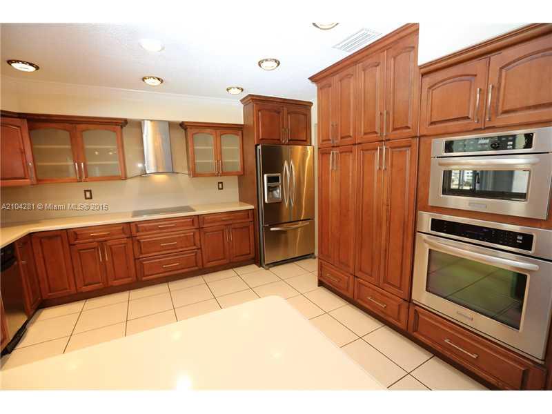 3845 Southwest 128th Avenue Miami, FL 33175 - Photo 12 of 35 a kitchen with stainless steel appliances granite countertop a refrigerator and a stove top oven