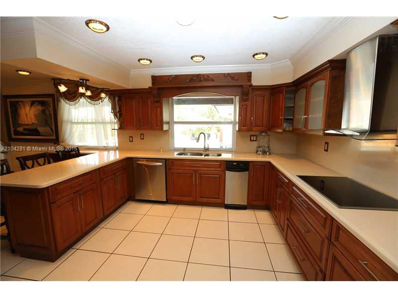 3845 Southwest 128th Avenue Miami, FL 33175 - Photo 13 of 35 a large kitchen with stainless steel appliances granite countertop a sink counter space cabinets and a large window
