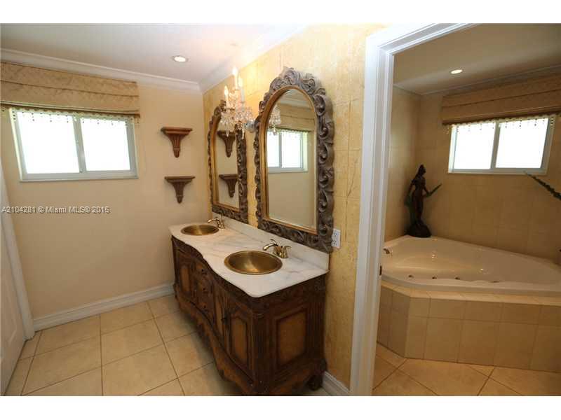 3845 Southwest 128th Avenue Miami, FL 33175 - Photo 16 of 35 a bathroom with a sink and a mirror