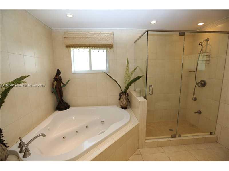 3845 Southwest 128th Avenue Miami, FL 33175 - Photo 17 of 35 a bathroom with a bathtub and a shower