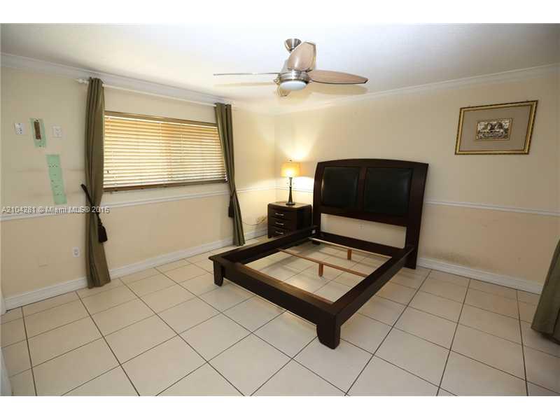 3845 Southwest 128th Avenue Miami, FL 33175 - Photo 20 of 35 a living room with a couch and a table