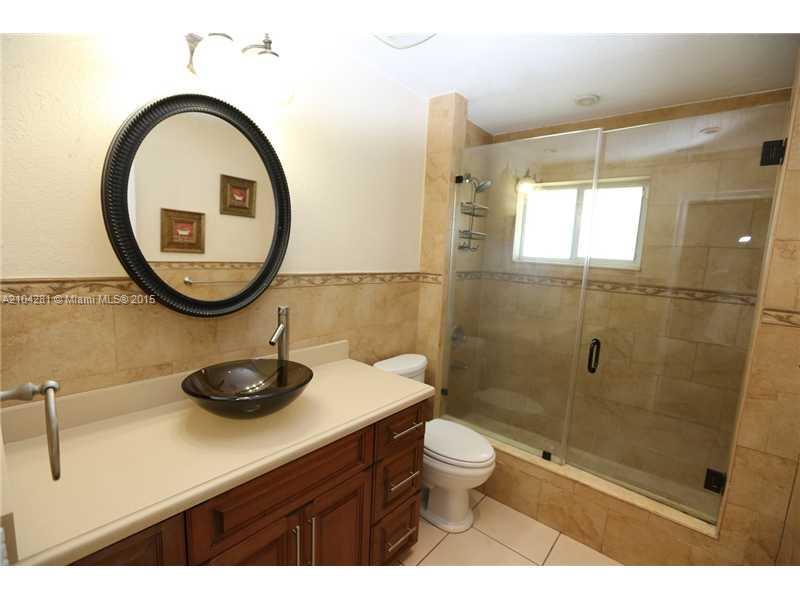 3845 Southwest 128th Avenue Miami, FL 33175 - Photo 21 of 35 a bathroom with a sink a toilet and a mirror