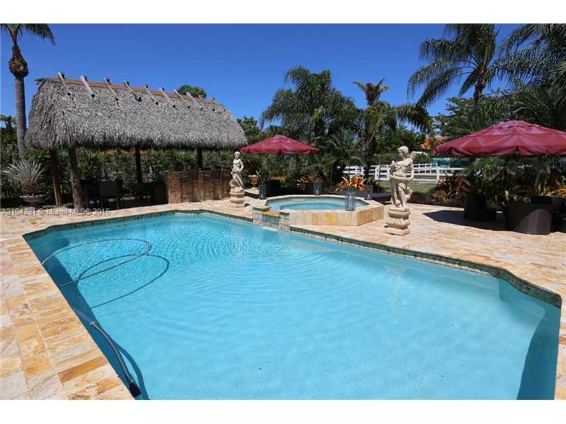 3845 Southwest 128th Avenue Miami, FL 33175 - Photo 25 of 35 a view of a swimming pool with a table under an umbrella
