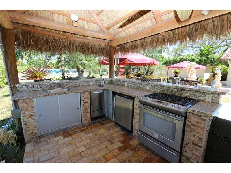 3845 Southwest 128th Avenue Miami, FL 33175 - Photo 27 of 35 a kitchen with stainless steel appliances granite countertop a stove a sink and a microwave
