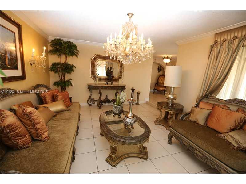 3845 Southwest 128th Avenue Miami, FL 33175 - Photo 6 of 35 a living room with furniture and a chandelier