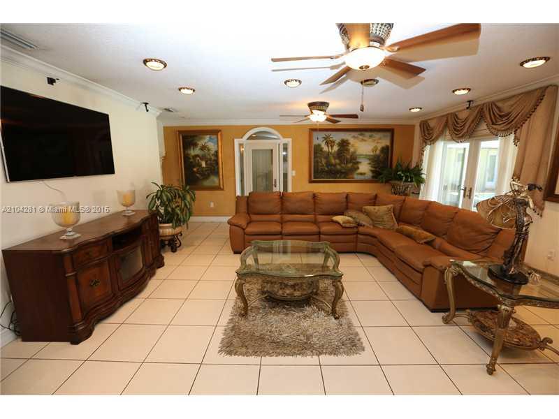 3845 Southwest 128th Avenue Miami, FL 33175 - Photo 9 of 35 a living room with furniture and a flat screen tv