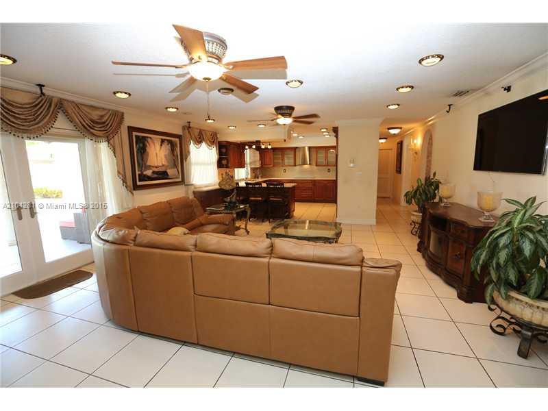 3845 Southwest 128th Avenue Miami, FL 33175 - Photo 10 of 35 a living room with furniture and a flat screen tv