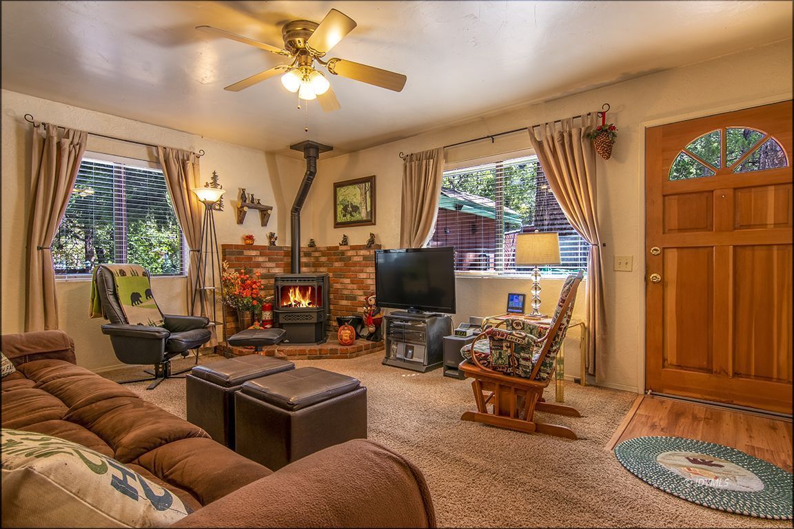26833 Idyllwild Road Idyllwild, CA 92549 - Photo 15 of 38 a living room with furniture a flat screen tv and a large window
