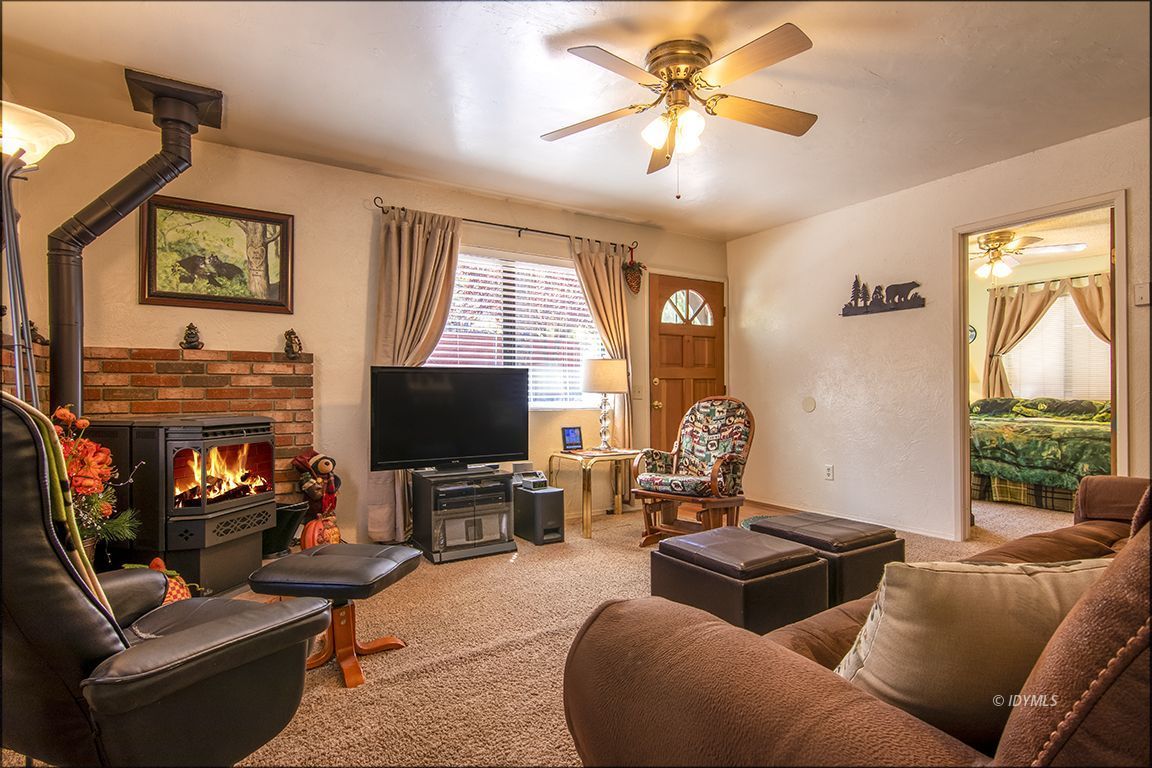 26833 Idyllwild Road Idyllwild, CA 92549 - Photo 17 of 38 a living room with furniture a fireplace and a flat screen tv