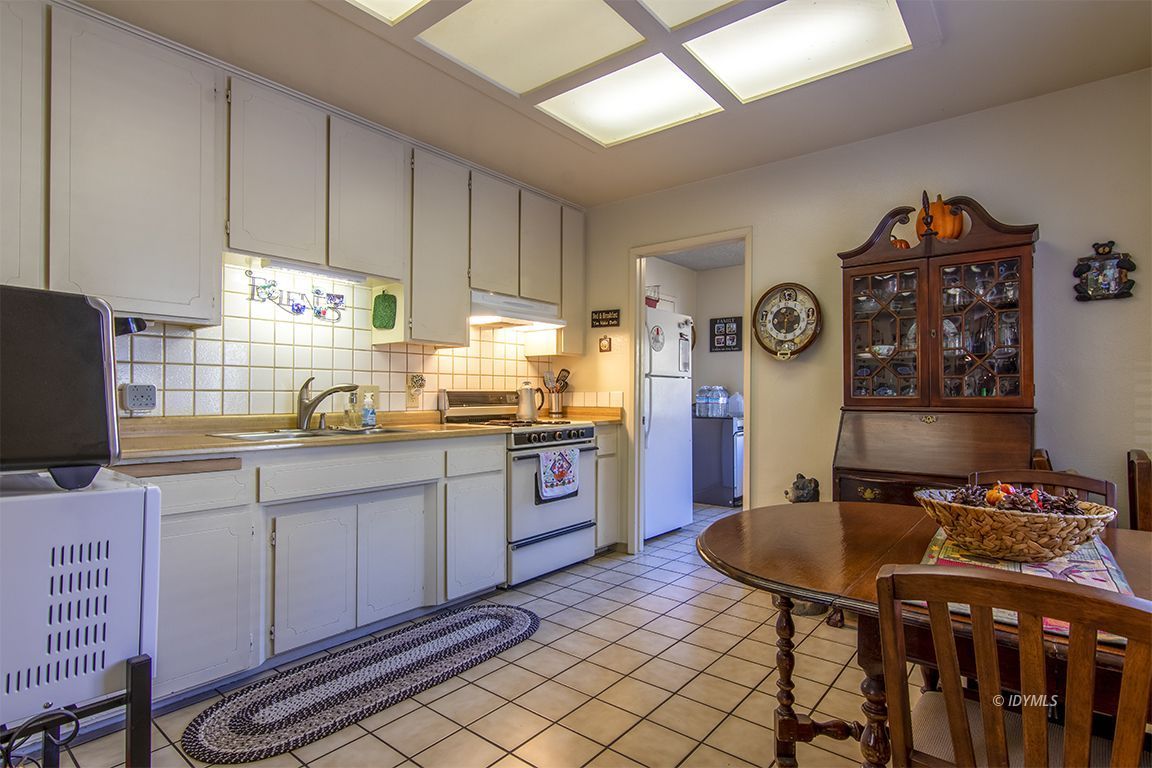 26833 Idyllwild Road Idyllwild, CA 92549 - Photo 18 of 38 a kitchen with stainless steel appliances kitchen island granite countertop a sink a stove a refrigerator and cabinets