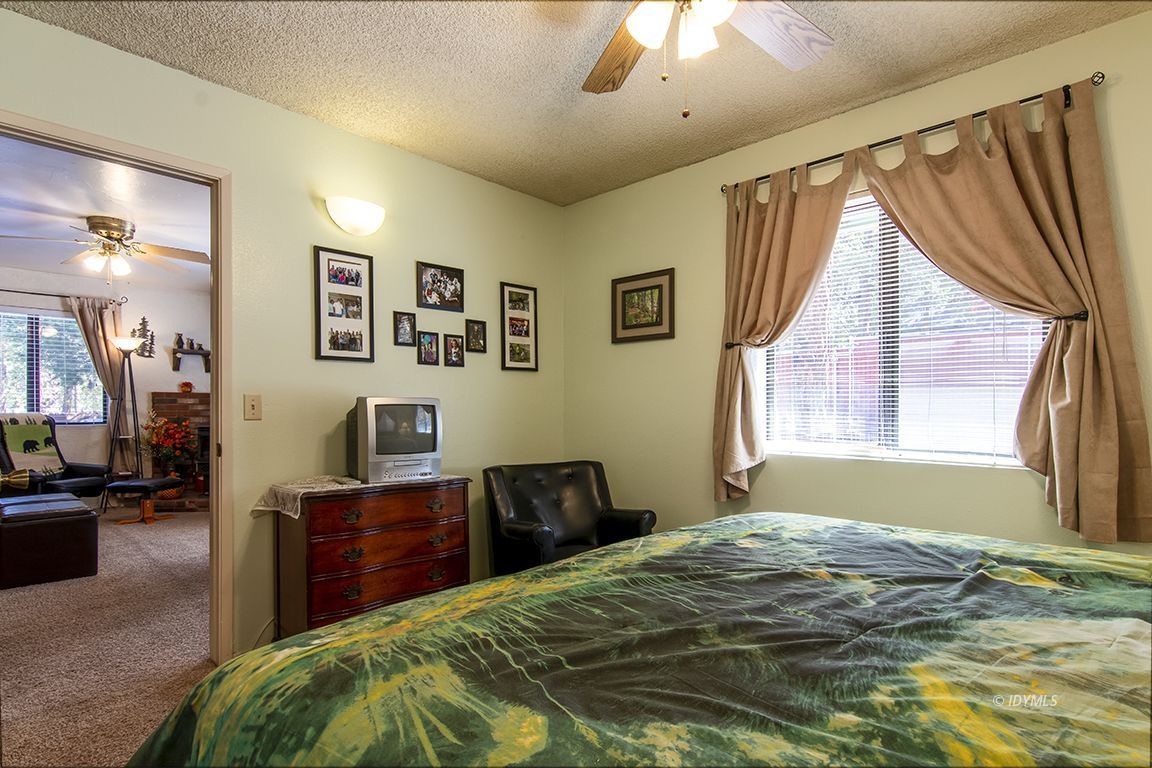 26833 Idyllwild Road Idyllwild, CA 92549 - Photo 27 of 38 a bedroom with a bed and a chandelier