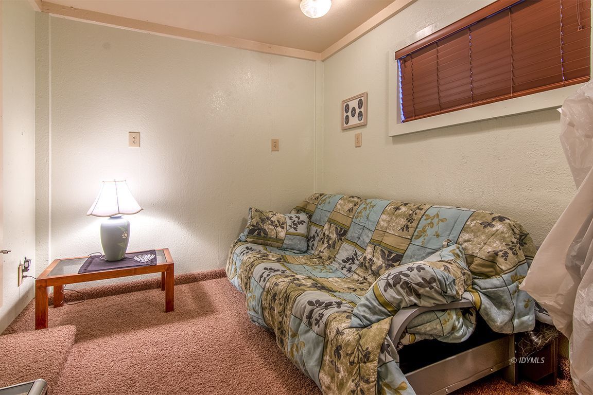 26833 Idyllwild Road Idyllwild, CA 92549 - Photo 32 of 38 a bed sitting in a bedroom next to a lamp