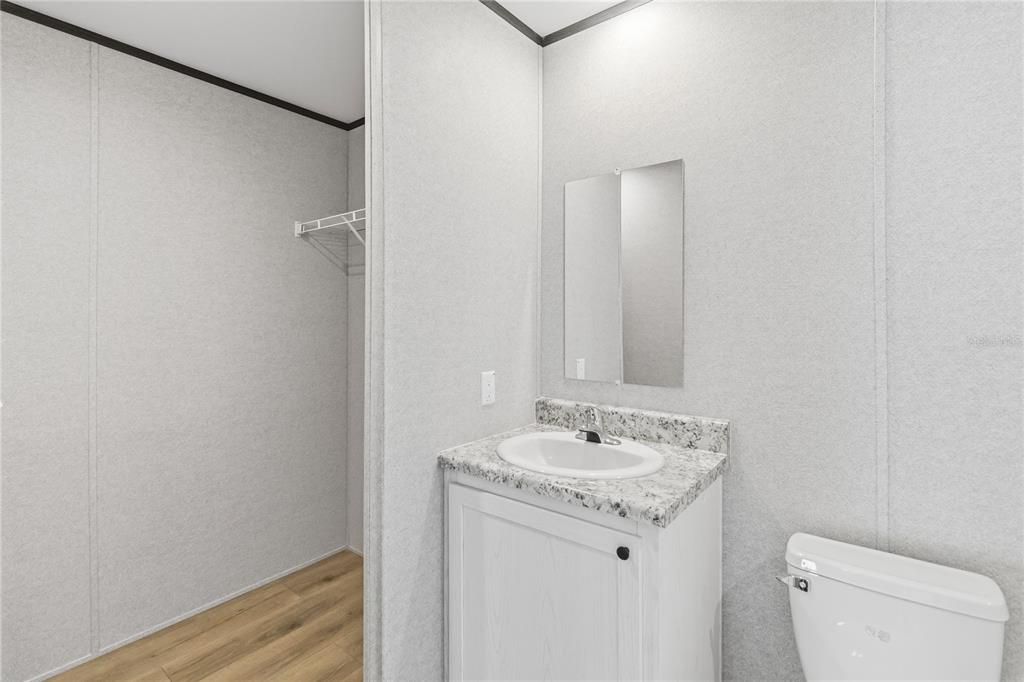 2003 Oak Street St. Cloud, FL 34769 - Photo 15 of 20 a bathroom with a sink toilet and vanity