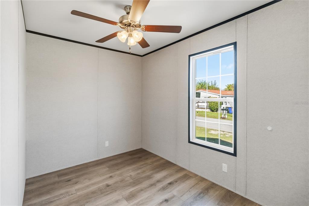 2003 Oak Street St. Cloud, FL 34769 - Photo 18 of 21 an empty room with windows and fan