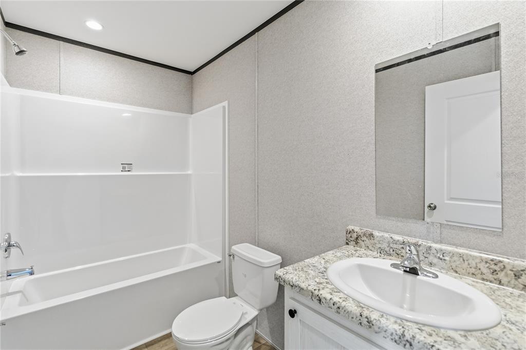 2003 Oak Street St. Cloud, FL 34769 - Photo 19 of 20 a bathroom with a sink toilet and shower