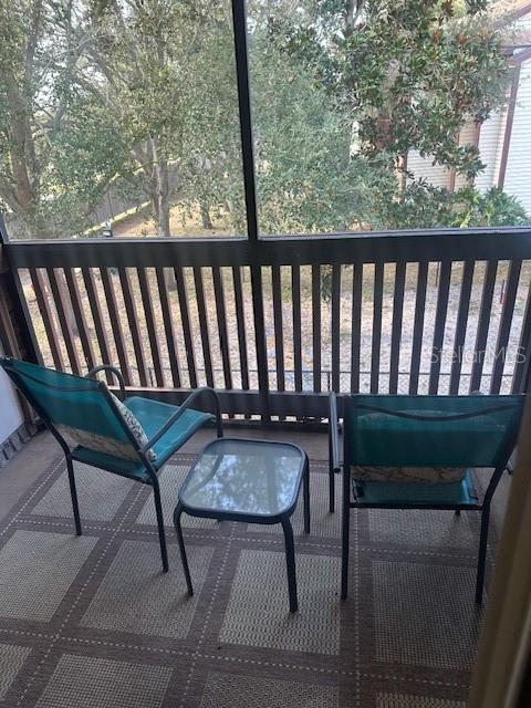 1793 Hampton Lane, Unit 110 Palm Harbor, FL 34683 - Photo 15 of 35 a view of a balcony with chairs
