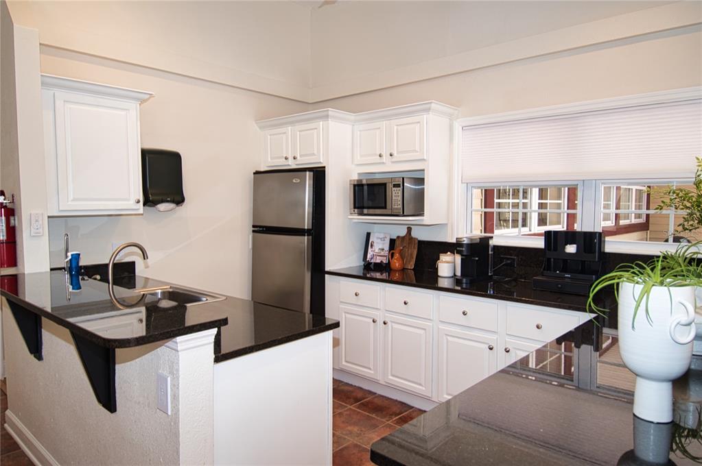1793 Hampton Lane, Unit 110 Palm Harbor, FL 34683 - Photo 35 of 35 a kitchen with stainless steel appliances a stove refrigerator sink and white cabinets